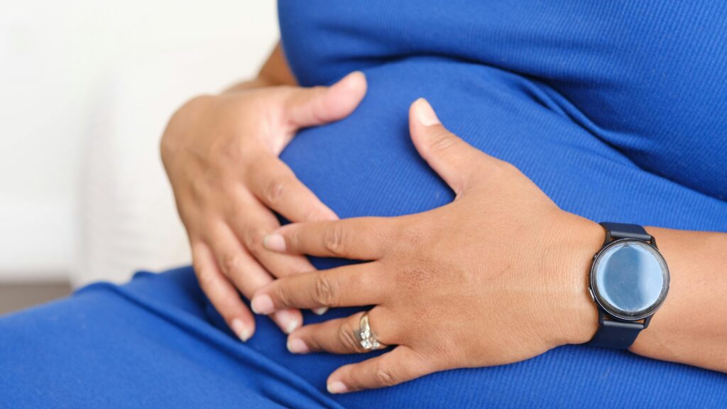 Pregnant woman holds her belly