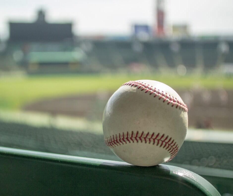 Baseball on seat railing with field view
